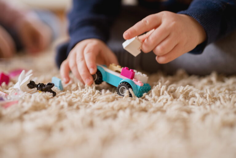 close-up-focus-view-plastic-toy-car-from-blocks-while-little-boy-hands-making-new-shape (1)