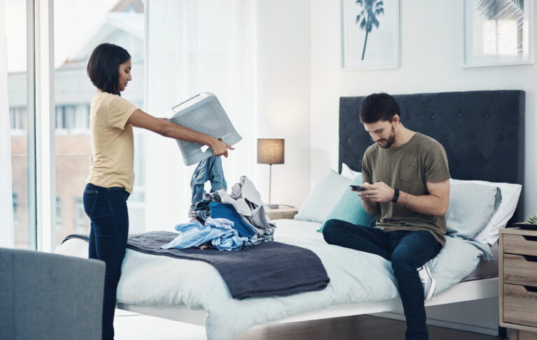 laundry-phone-couple-with-clothes-home-cleaning-chore-routine-hygiene-marriage-housewife-lazy-man-smartphone-woman-with-basket-housekeeping-maintenance-housework (1)